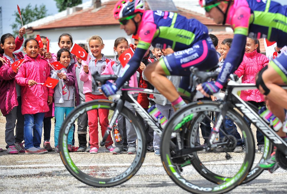 Young spectators watch the peloton pass by at Tour of Turkey.