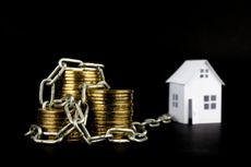 money chained gold coins white small house on a black background selective focus