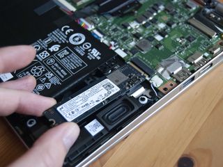 Pull the old SSD away from the slot