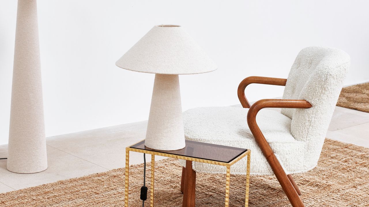 Oliver Bonas Alma White Boucle Desk &amp; Table Light on a side table next to a cream shearling accent chair