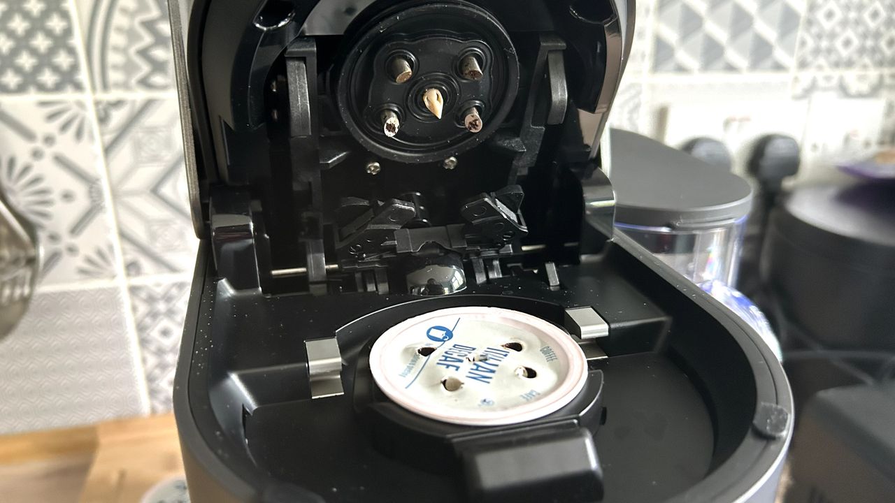 Keurig K-Crema capsule espresso machine containing used coffee pod