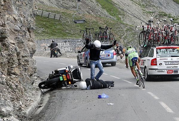 A Liquigas rider diverts an accident on the road with one of the race motorbikes.