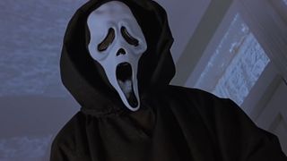 The Ghostface stands over his victim in Scream