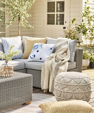 A nautical inspired external scheme with outdoor sofa furniture, cushions and pouffe decor