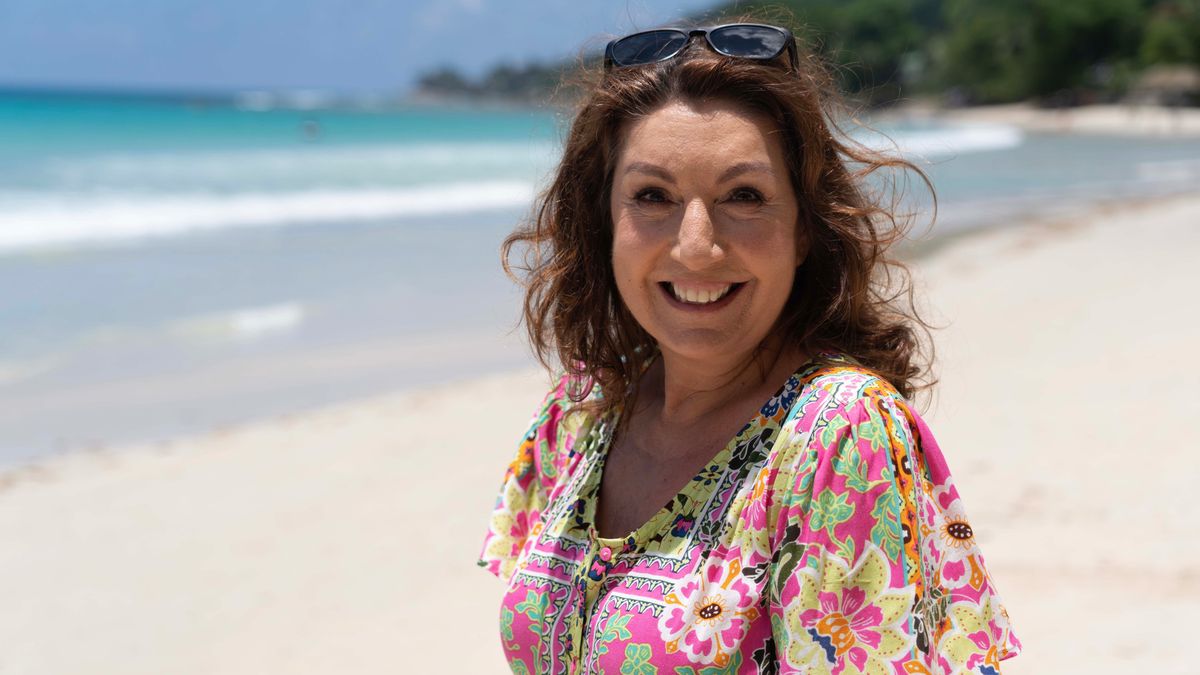 Jane McDonald poses on a beach for The Seychelles with Jane McDonald