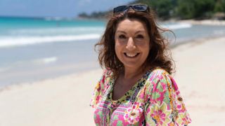 Jane McDonald poses on a beach for The Seychelles with Jane McDonald
