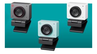 Three Obsbot Meet 2 webcams on a blue background