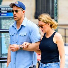 Blake Lively and Ryan Reynolds walk together wearing sunglasses