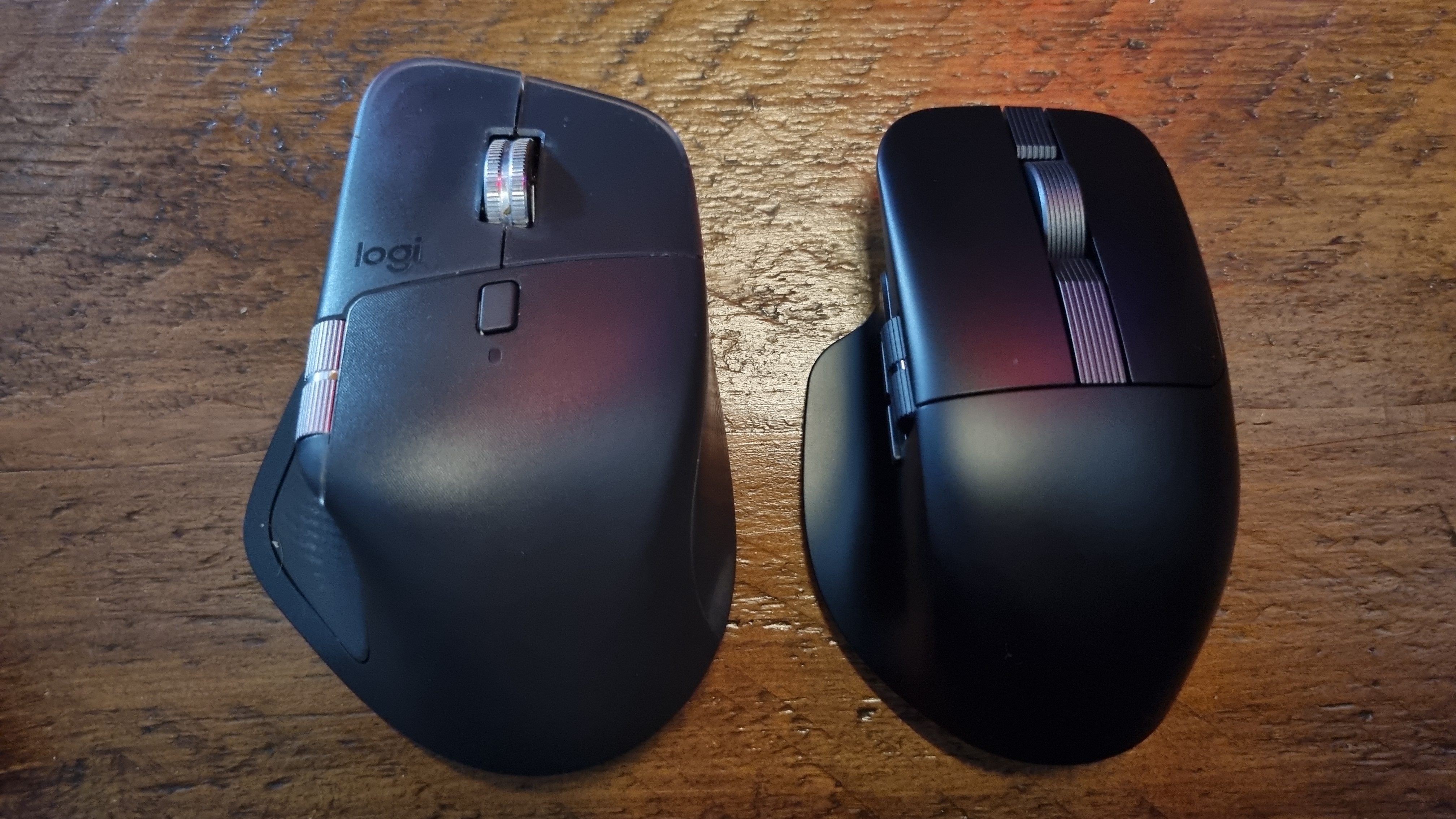 An Asus ProArt Mouse MD301 next to a Logitech MX Master 4