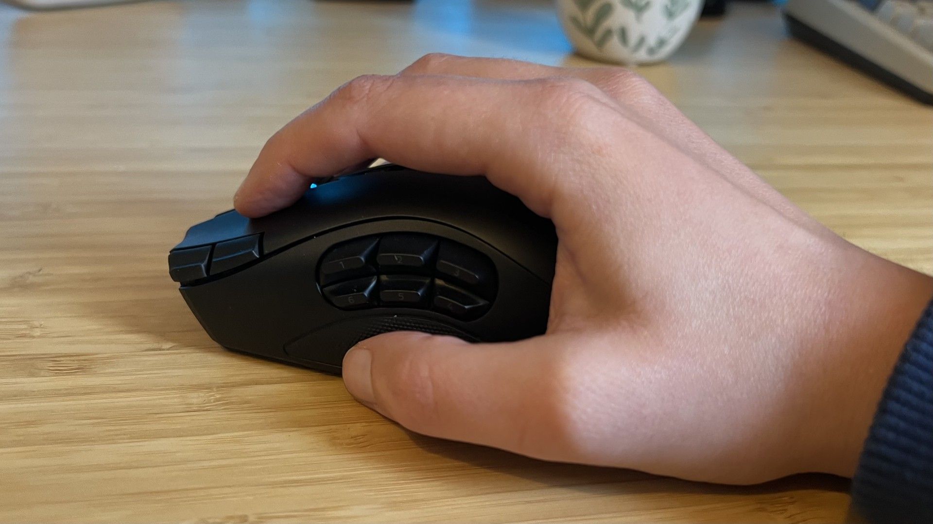 Hand using the Razer Naga V3 Pro in a palm grip