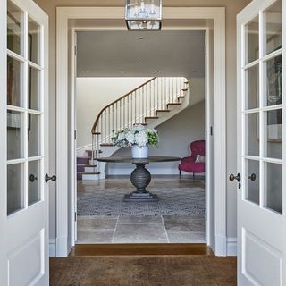 entrance hall with white door and flower vase