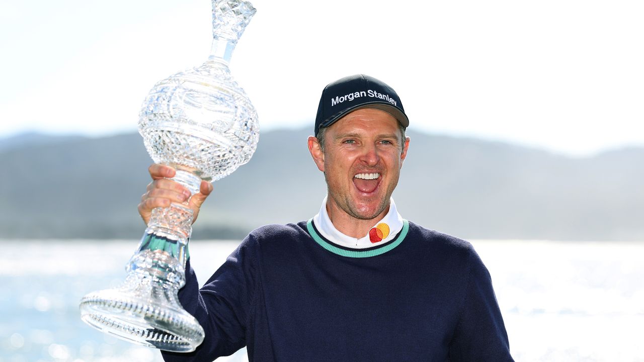 Justin Rose celebrates holding the AT&amp;T Pebble Beach Pro-Am trophy