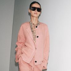 a Zara model wears a pink blazer and pink Bermuda shorts