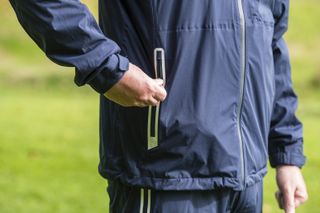 zipped pocket of the Inesis Men's Golf Waterproof Rain Jacket