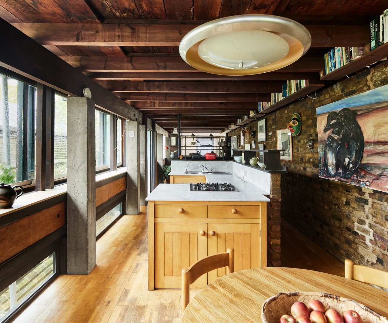A wooden kitchen island with white marble top