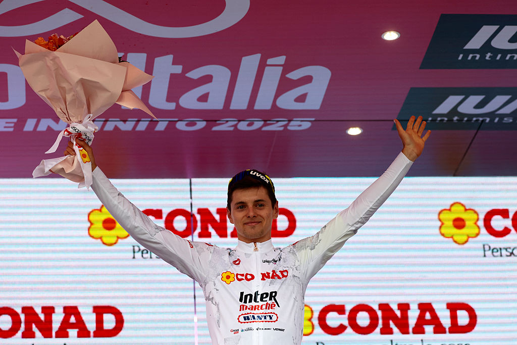 Intermarche-Wanty's Italian rider Francesco Busatto wears the white jersey of best young on the podium after the first stage of the 108th Giro d'Italia cycling race, 160km from Durres to Tirana in Albania, on May 9, 2025. (Photo by Luca Bettini / AFP)
