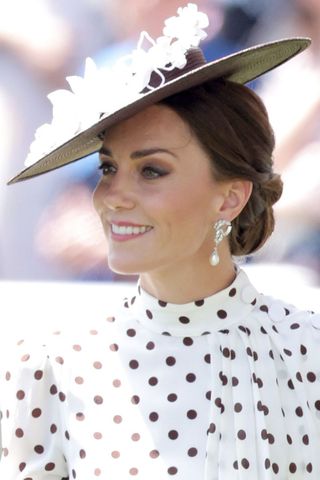 Kate Middleton headshot with a low bun hairstyle and fascinator