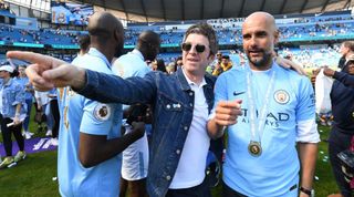 Noel Gallagher and Pep Guardiola at Manchester City celebrating a Premier League title win