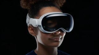 A woman wearing the Apple Vision Pro headset