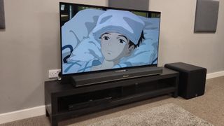 Q Acoustics Q Sub120 next to Marshall Heston 120 with TV playing The Boy and the Heron