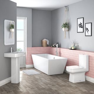 modern bathroom with a contemporary bathroom suite, pink metro tiles and grey walls