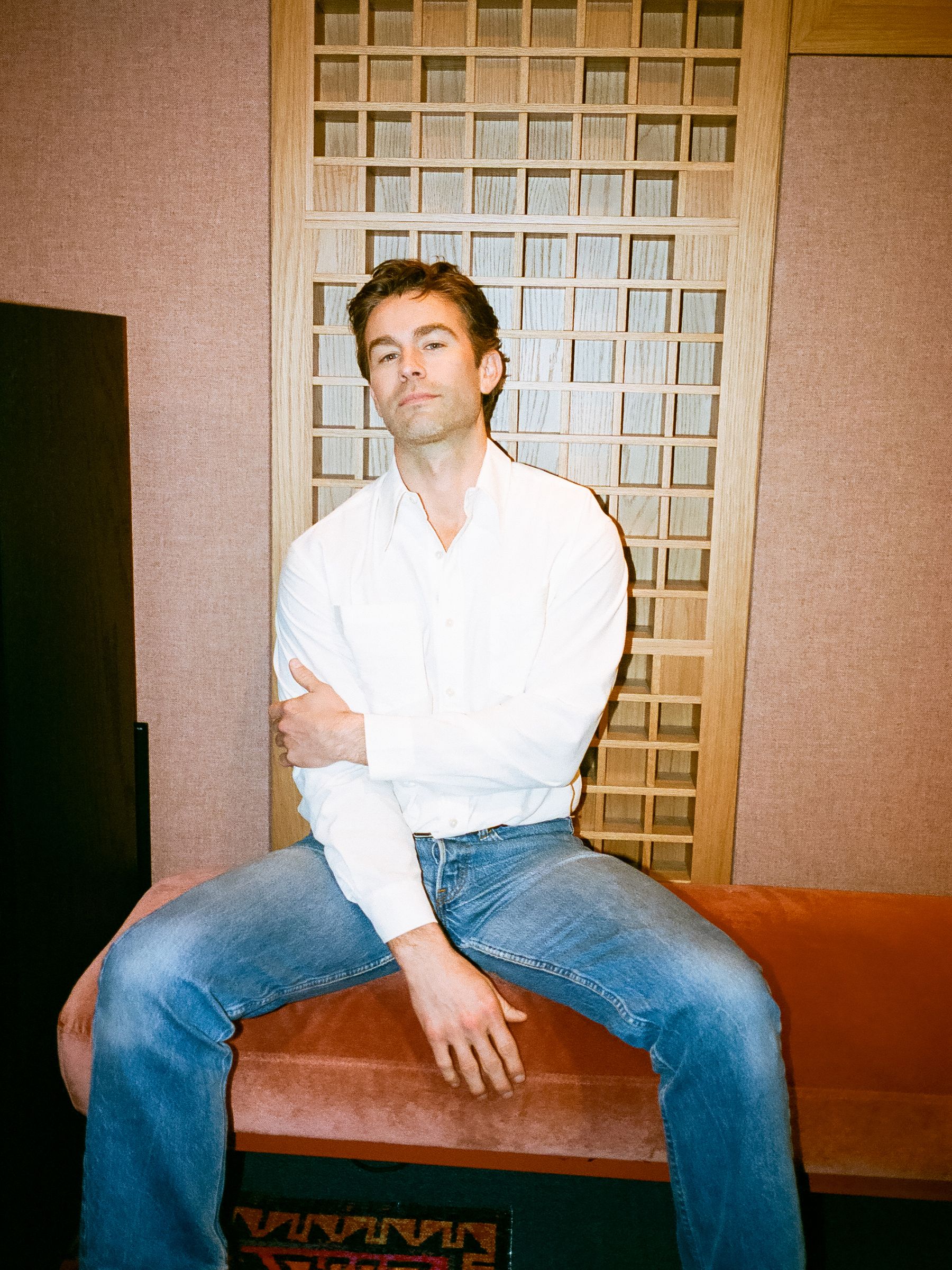 Chace Crawford wearing a plain white button-down shirt and blue jeans.