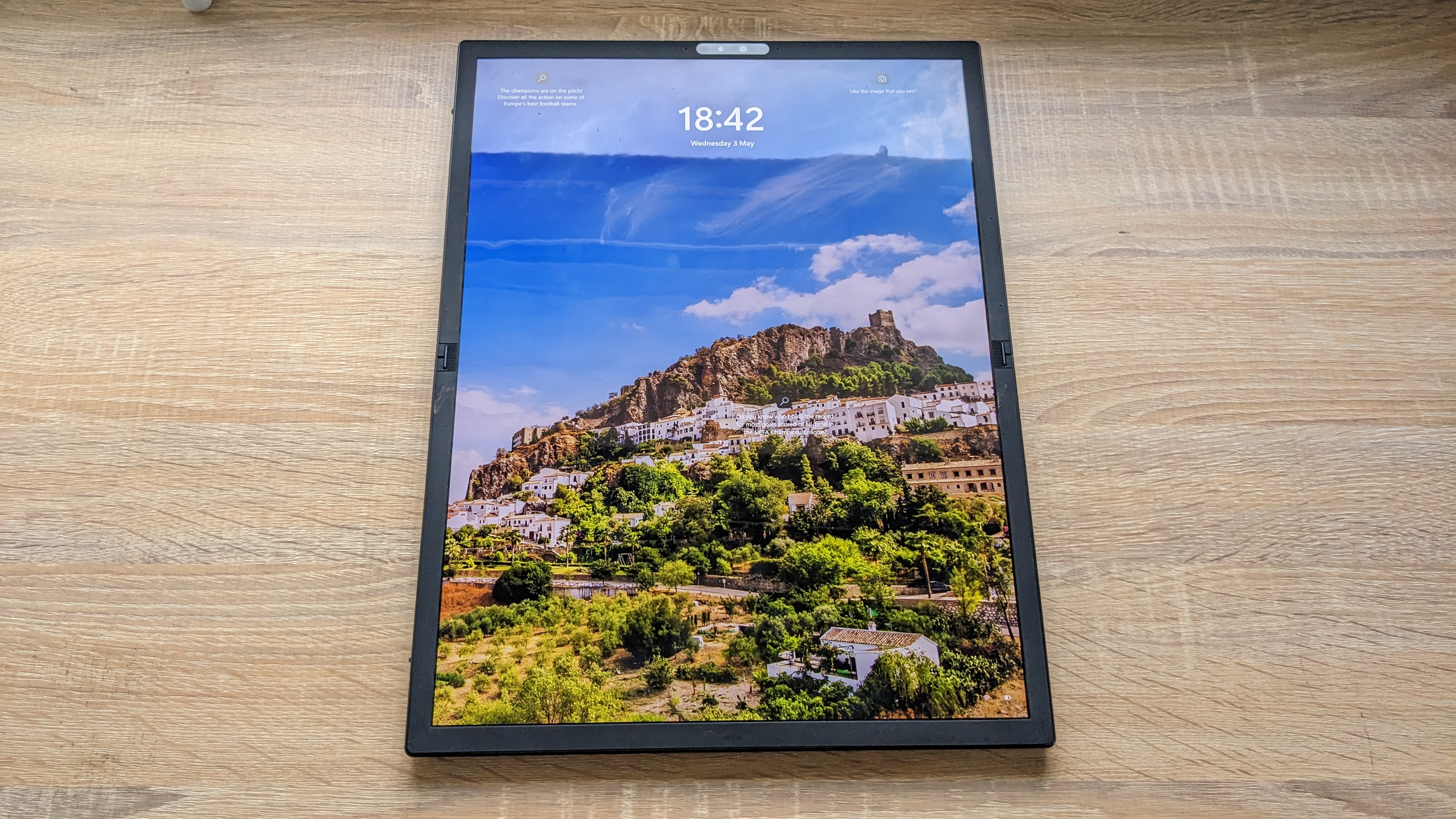 The Asus Zenbook 17 Fold OLED pictured on a wooden desk.