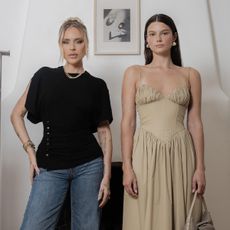 Stylist Maeve Riley stands in black t-shirt and jeans next to Rent the Runway model wearing tan drop-waist dress.