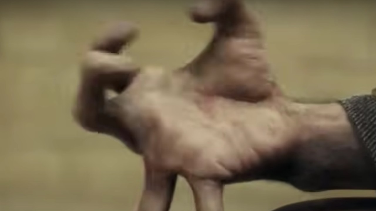 A hand transforming gruesomely in The Wolfman