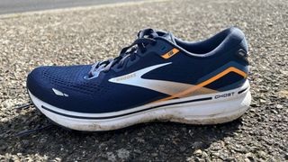 The Brooks Ghost 15 shoe in navy on a sidewalk