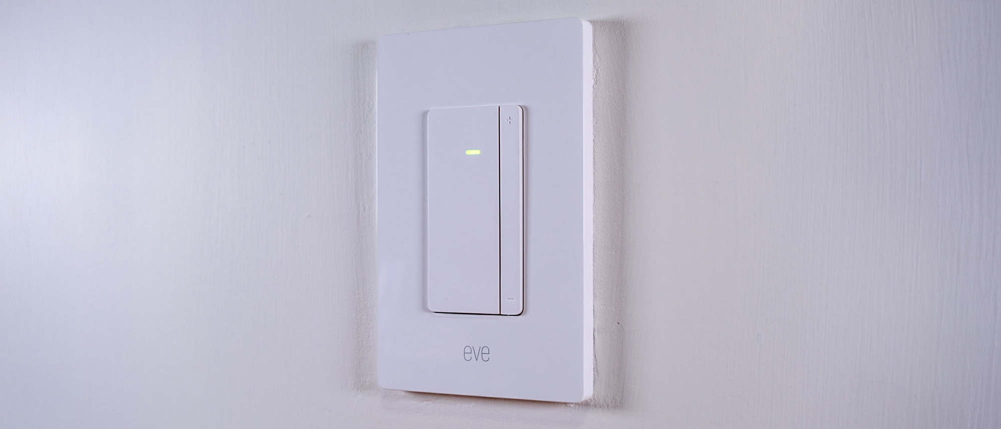 The Eve Dimmer Switch mounted on a white wall