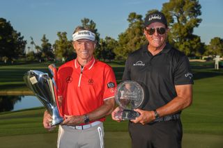 Langer and Mickelson hold their trophies