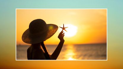 woman at the beach in hat holding seashell to sunset sky representing july astrology events