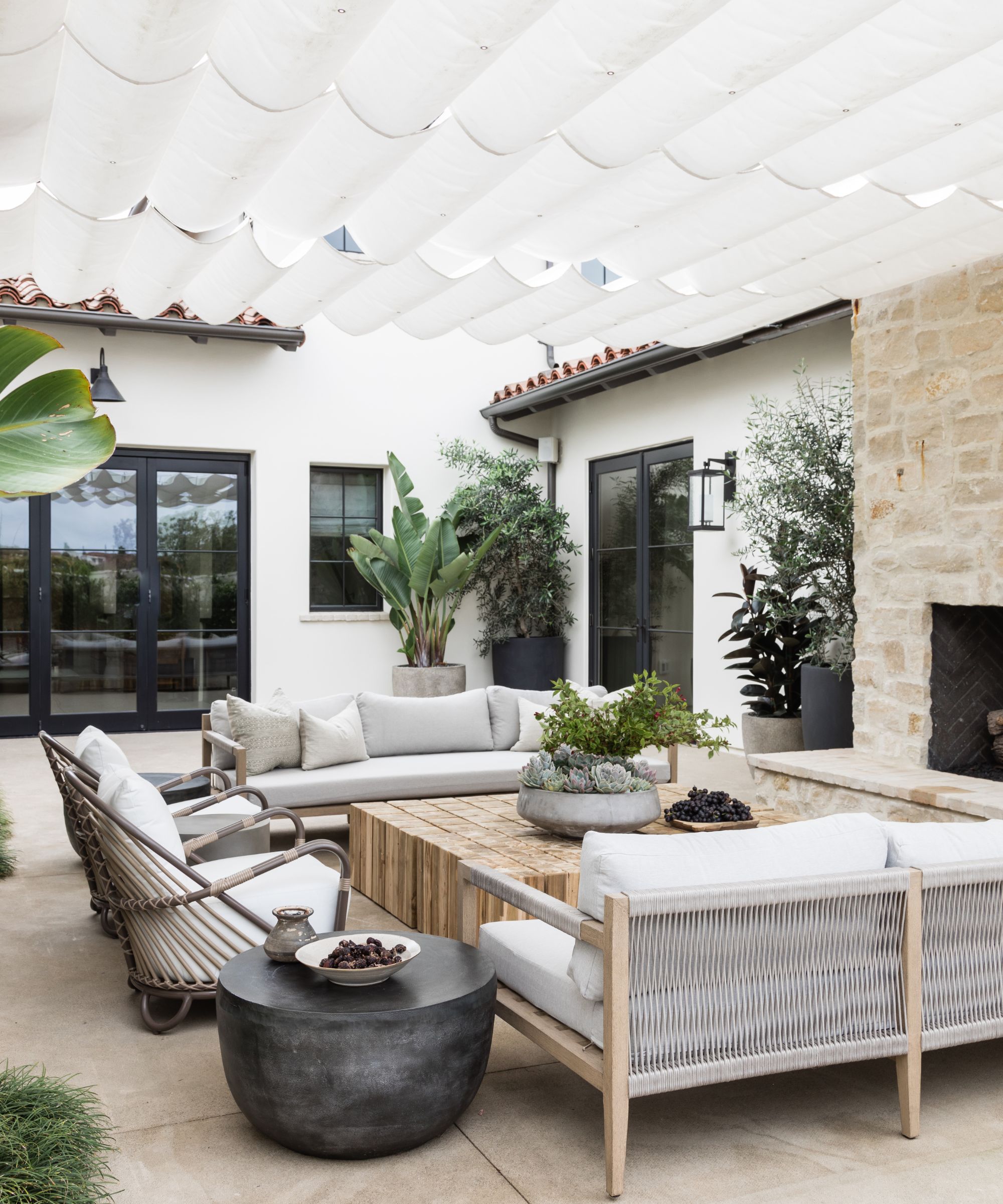 Neutral outdoor living room with fabric shades