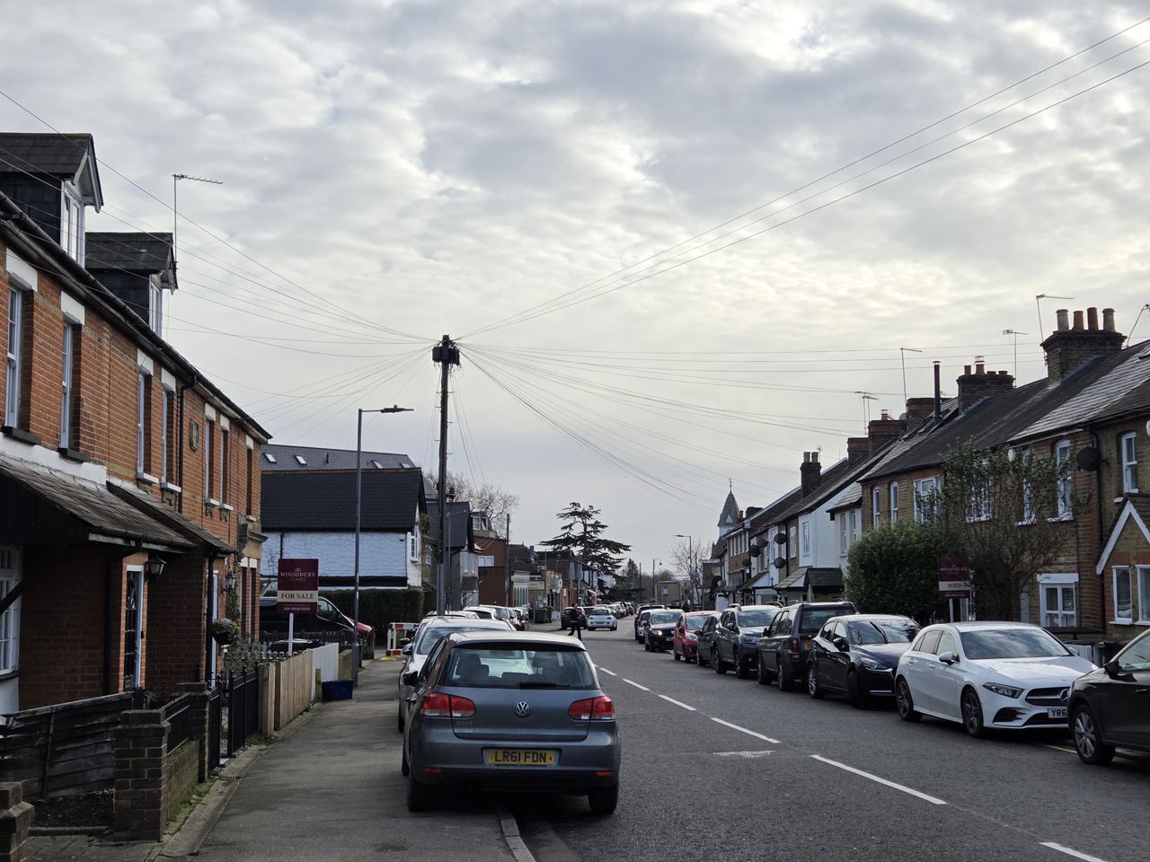 A street scene of parked cars on a residential terrace