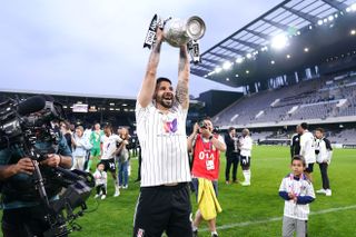 Aleksandar Mitrovic lifts the Championship trophy