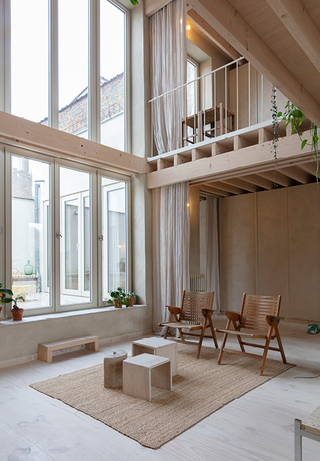 Exposed materials and double height spaces in Belgian home renovation by Hé Architectuur