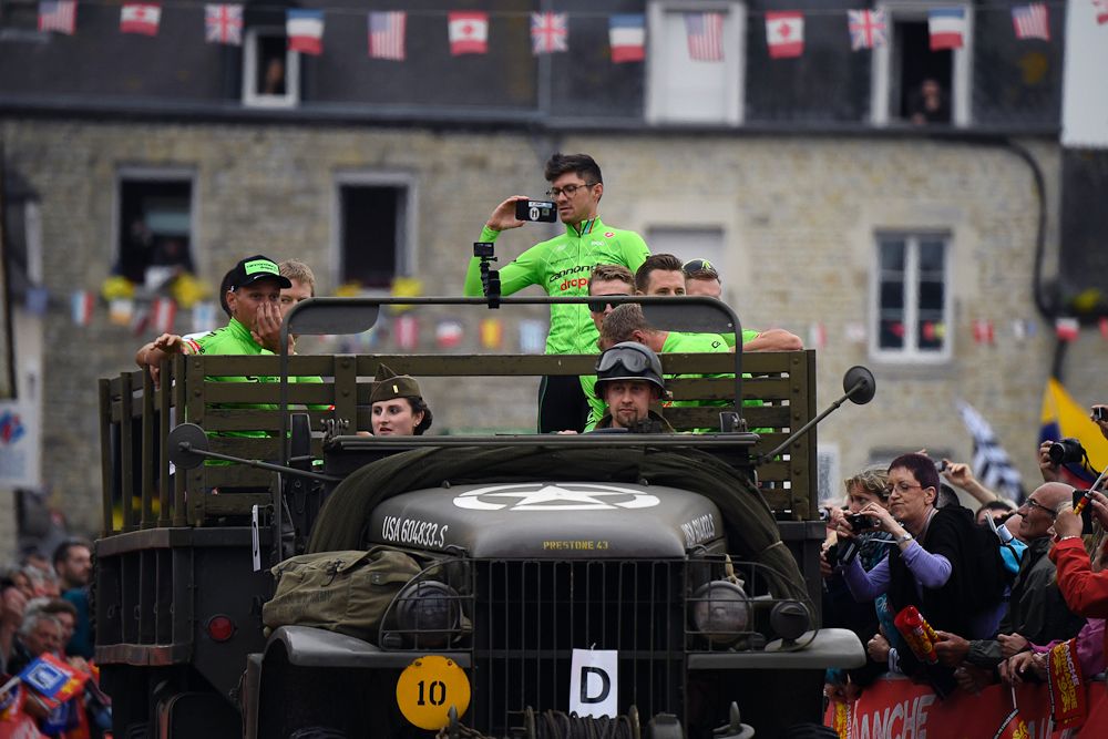 Riders of the USA's Cannondale cycling team take part in a parade aboard an World War II US army jeep during the team presentation ceremony