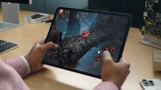 A photo of someone playing a game on the new iPad Pro
