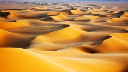 sunrise over sand dunes in the white desert in Egypt