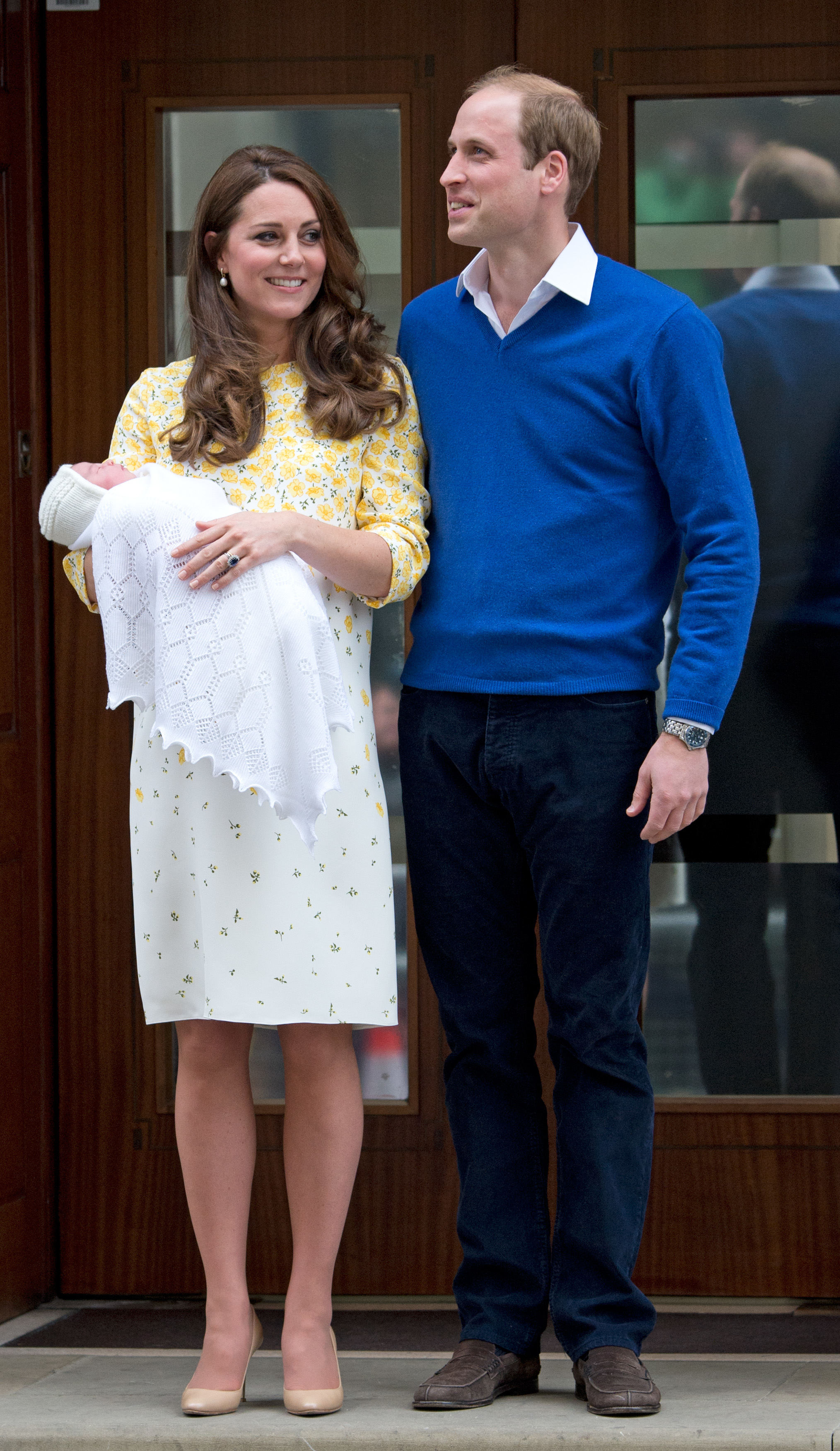 Prince William and Princess Kate holding Princess Charlotte outside the hospital