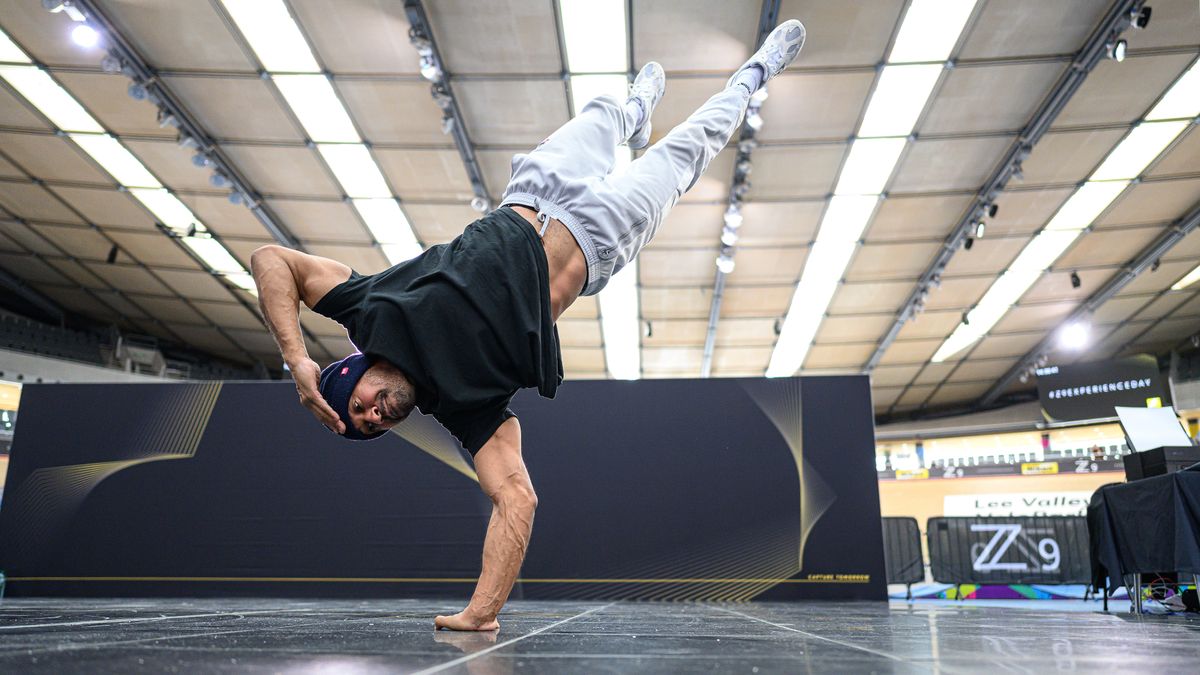 A breakdancer standing on one arm