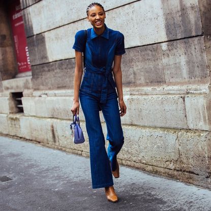 Fashion week attendees wears a denim jumpsuit