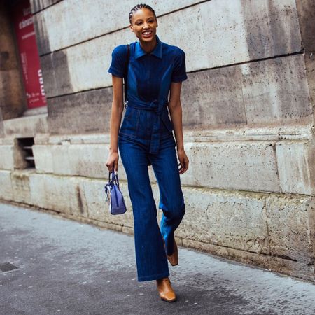 Fashion week attendees wears a denim jumpsuit