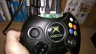 A close up photo of a person holding an Xbox controller