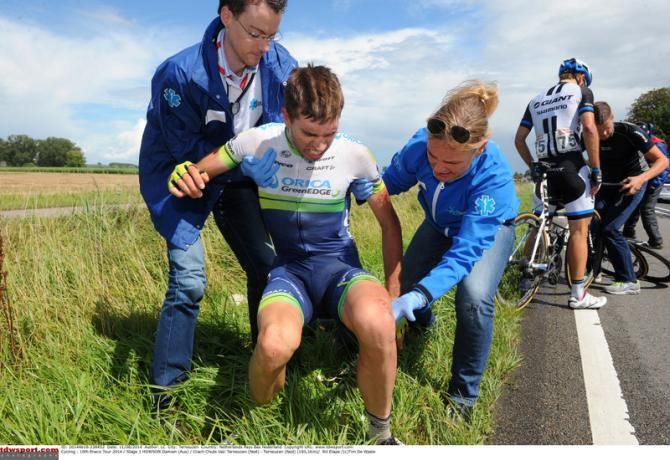 Orica-GreenEdge's Damien Howson receives a helping hand after crashing