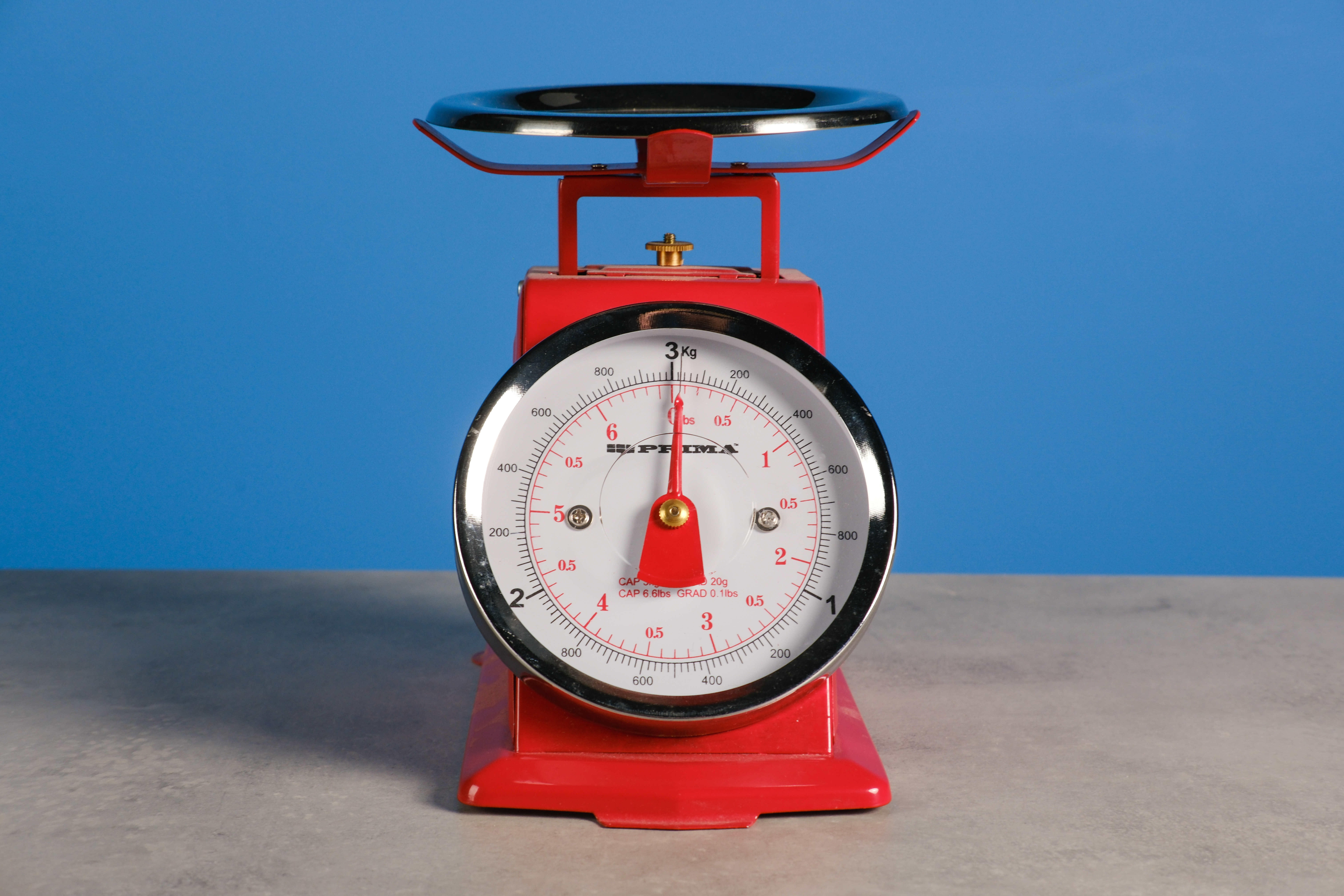 A red set of scales against a blue background