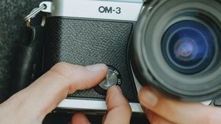 Closeup of the OM System OM-3 mirrorless camera's color mode dial in use