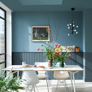 Farrow & Ball paint colour Selvedge in a dining room with wide bifold doors to the left