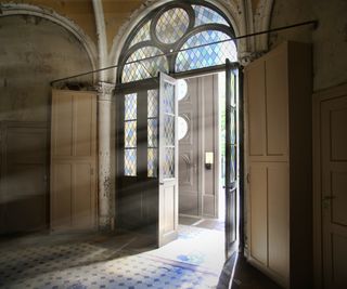 entrance to church with stained glass above doorway